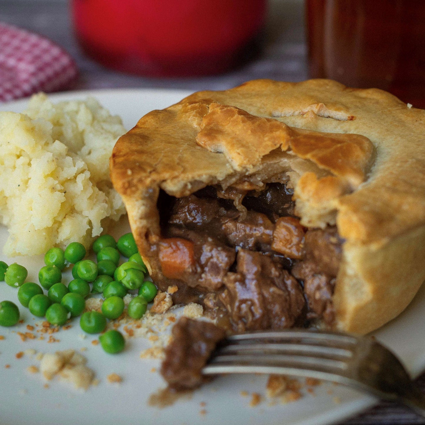The Complete Gift Box by Mud Pies presents a golden savoury pie with flaky pastry, tender beef and carrots in gravy, with mash and peas.