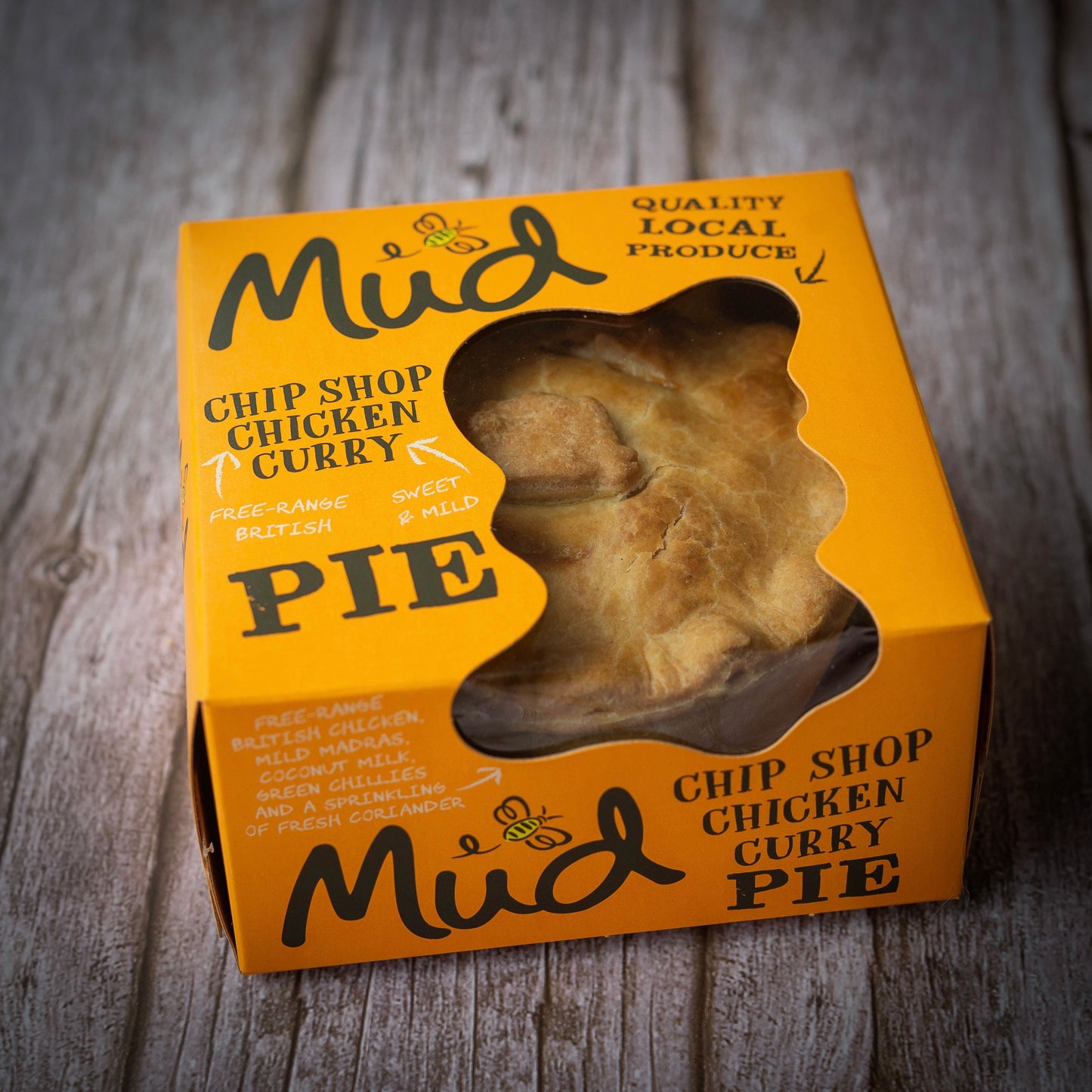 Mud Pies Ultimate Variety Christmas Gift Box on wood; festive, bold packaging shows pies made with local produce, free-range British chicken.
