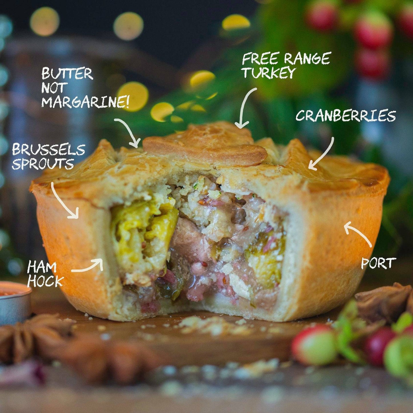 Mud Pies’ Gluten-Free Christmas In A Pie sits sliced on a board, revealing turkey, ham, sprouts, cranberries and walnuts.