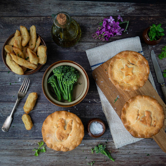 Top down image of pies, brocolli and chips