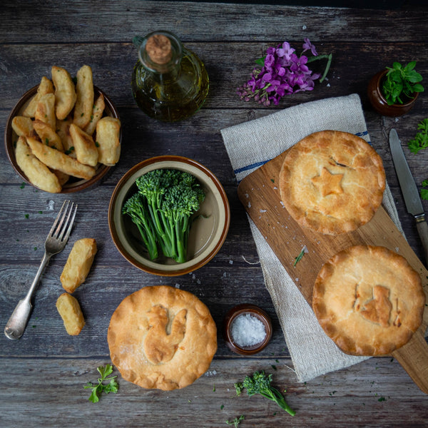 Top down image of pies, brocolli and chips