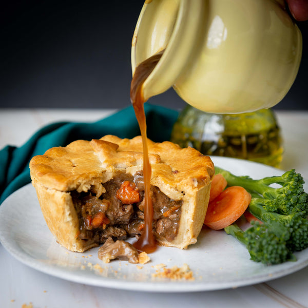 Lamb and mint pie with Gravy being poured