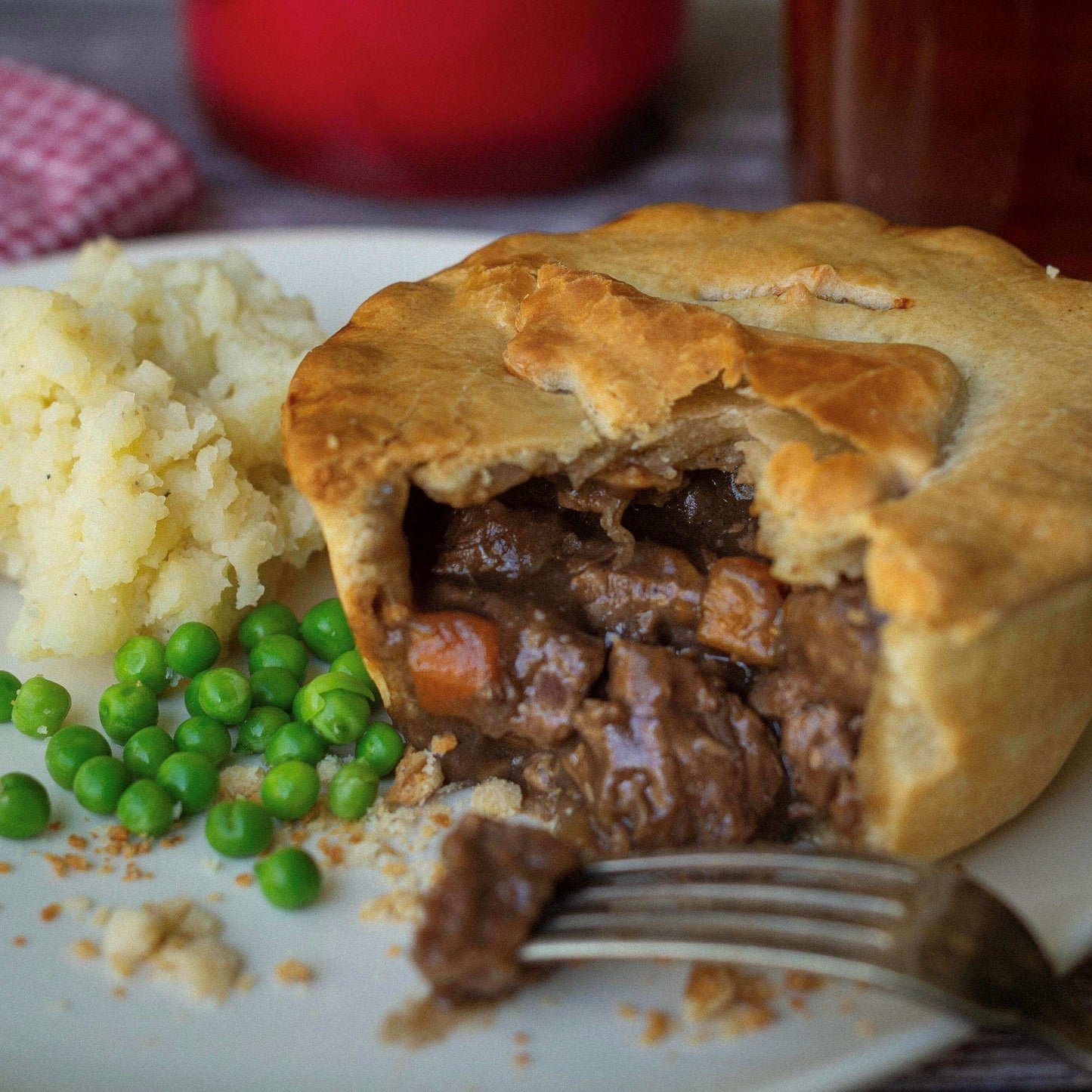 The Complete Gift Box by Mud Pies presents a golden savoury pie with flaky pastry, tender beef and carrots in gravy, with mash and peas.