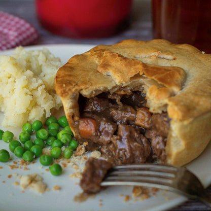 The Complete Gift Box by Mud Pies presents a golden savoury pie with flaky pastry, tender beef and carrots in gravy, with mash and peas.
