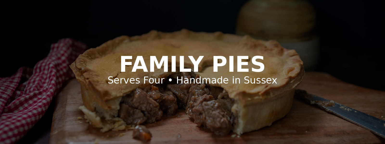 Mud Pies family-sized steak pie on wooden board – serves four