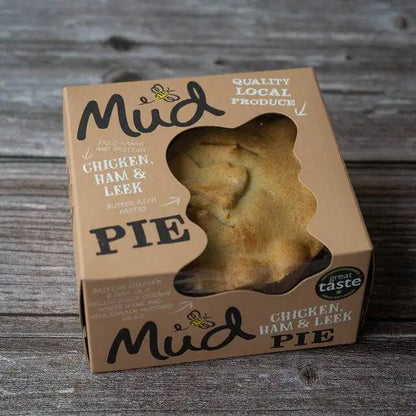 Mud Pies Try Me 5 Bundle, boxed, rests on a rustic wood table. The pack has hand-drawn text, bee art, award sticker and window.