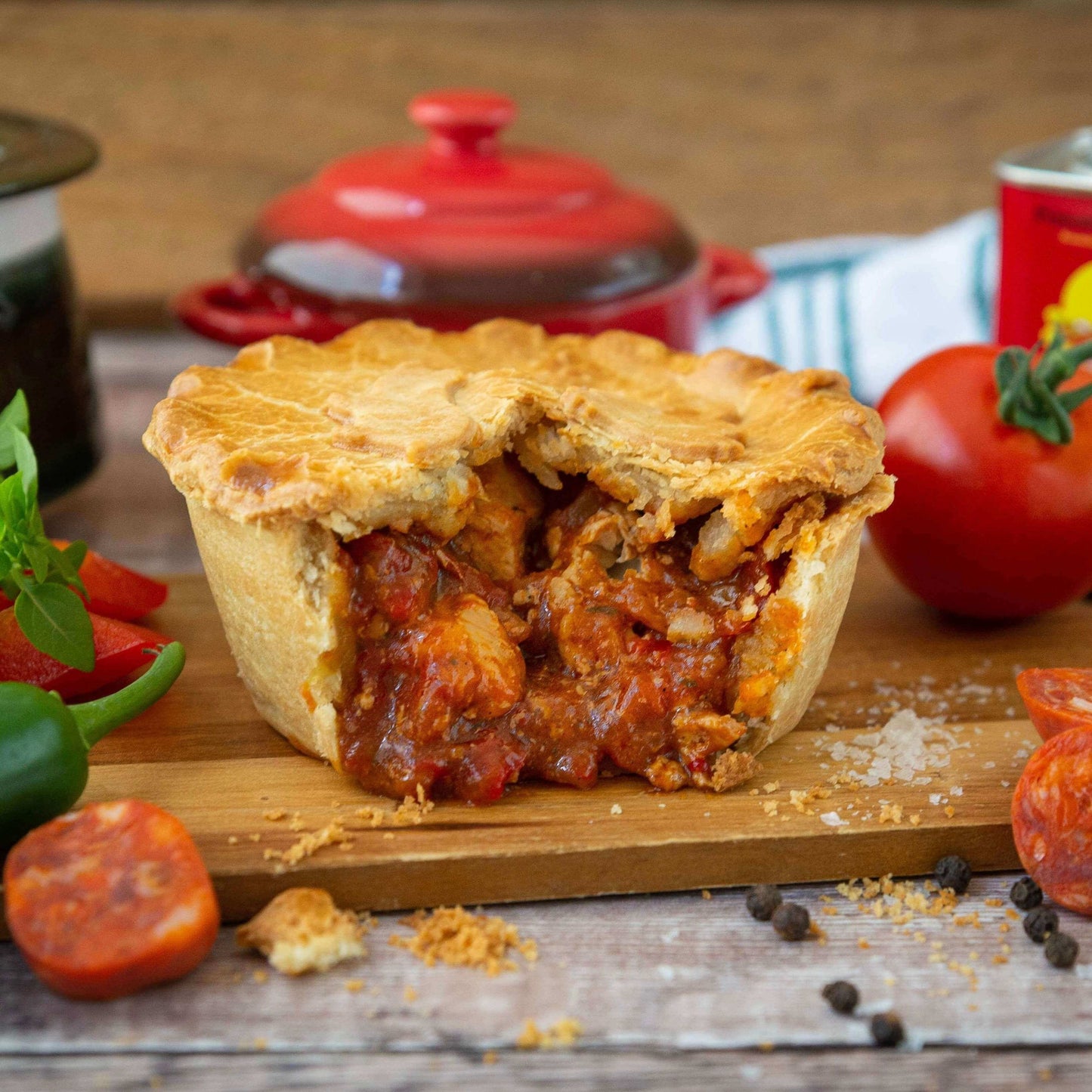 The Mud Pies Chicken and Spanish Chorizo Pie has a golden, flaky crust packed with tomato, cheese, chorizo, and rich spiced sauce.