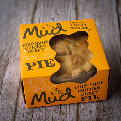 Mud Pies boxed pie in an orange Ultimate Variety Gift Box shows a golden crust through the window; made with British chicken.