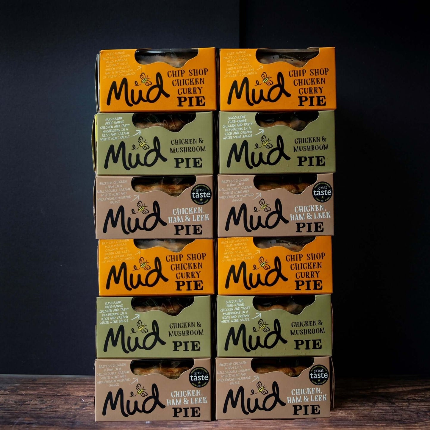 Nine Mud Pies Chicken Pie boxes—12 best-sellers—stacked in 3 columns. Flavours: Chip Shop Chicken Curry, Mushroom, Ham Leek.