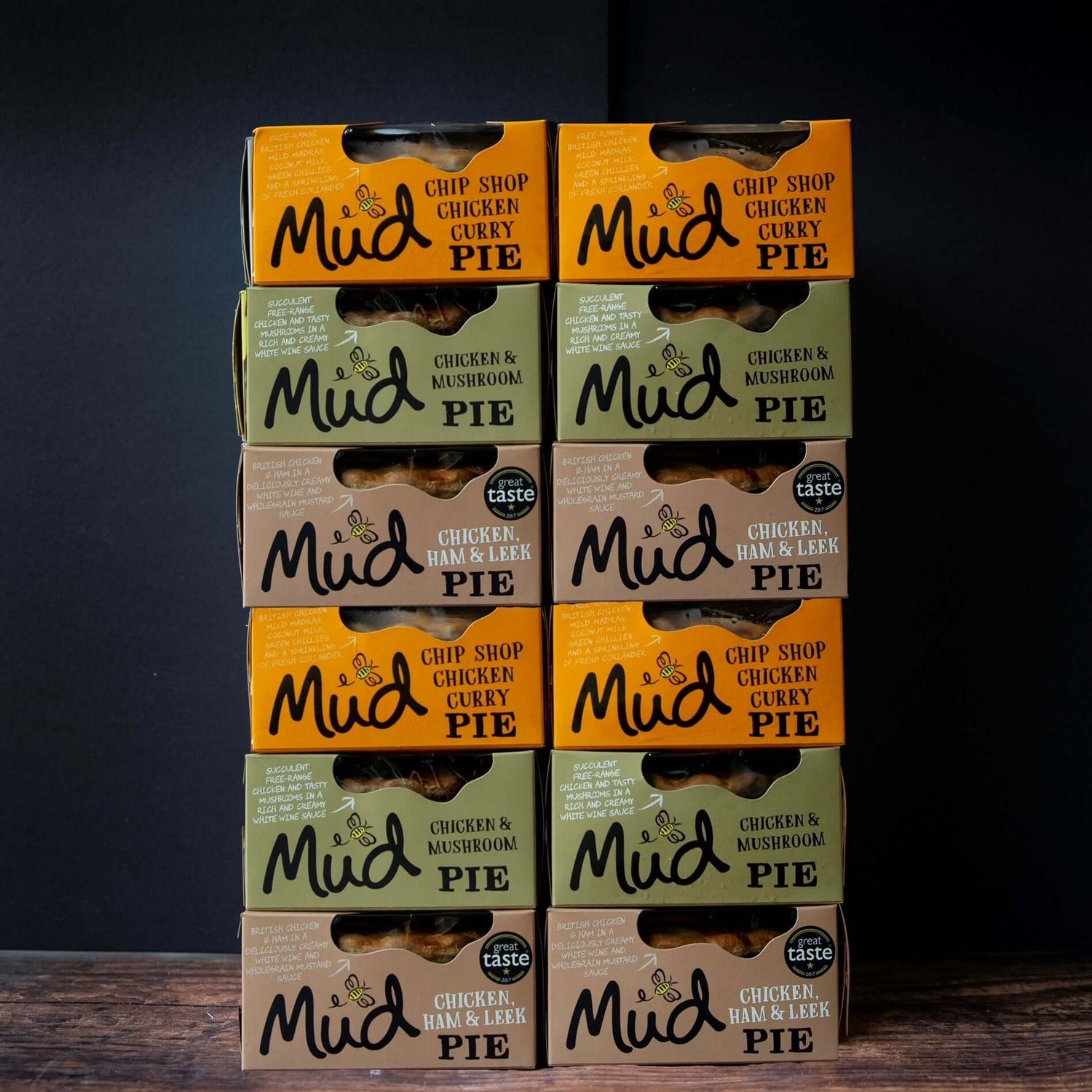 Nine Mud Pies Chicken Pie boxes—12 best-sellers—stacked in 3 columns. Flavours: Chip Shop Chicken Curry, Mushroom, Ham Leek.