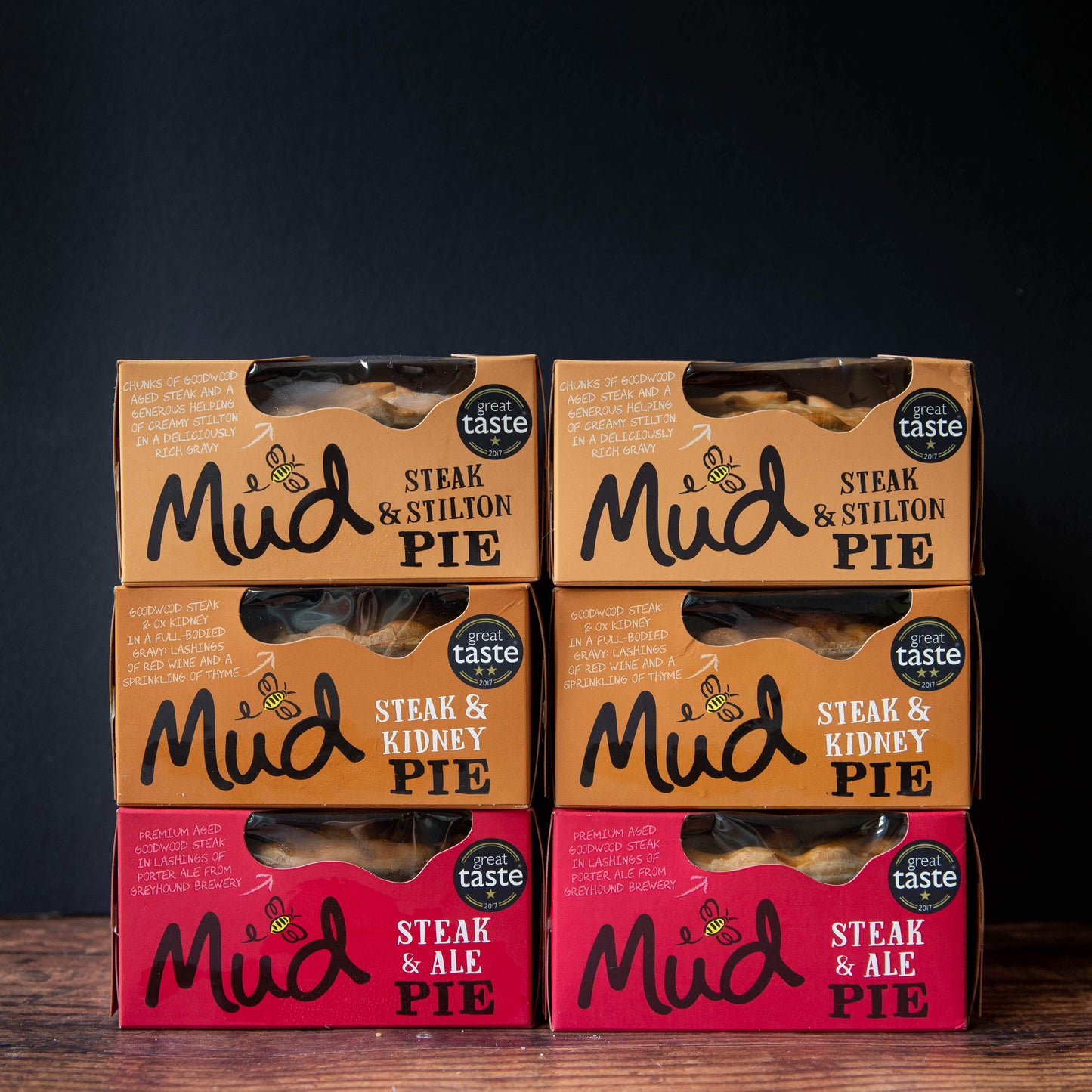 Six Mud Pies Steak Pie Boxes 6 Pack: four brown Steak Stilton and Steak Kidney boxes on top, two red Steak Ale below, all with "Great Taste" medals.