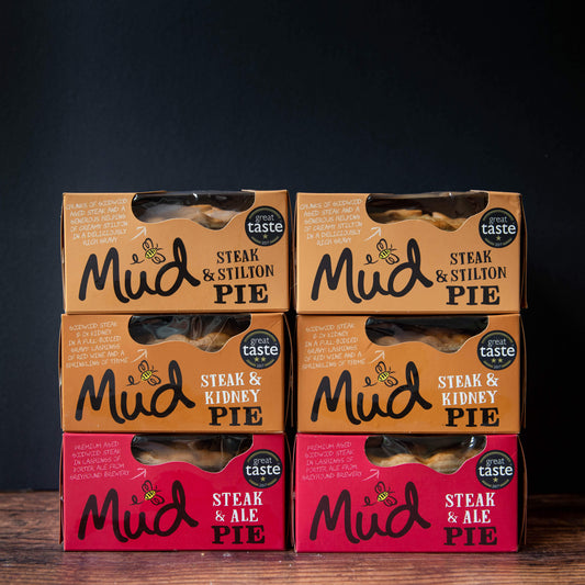 Six Mud Pies Steak Pie Boxes 6 Pack: four brown Steak Stilton and Steak Kidney boxes on top, two red Steak Ale below, all with "Great Taste" medals.